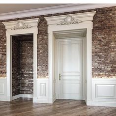 an empty room with brick walls and white trim on the doors is pictured in this image