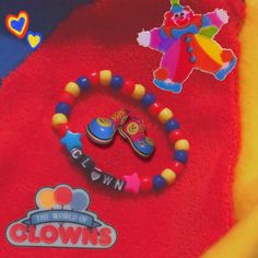 a close up of a bunch of beads on a blanket with clowns in the background