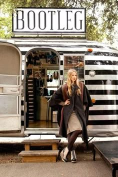 a woman standing in front of a food truck