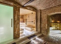 an indoor sauna room with stone walls and stairs