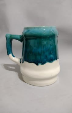 a blue and white mug sitting on top of a table