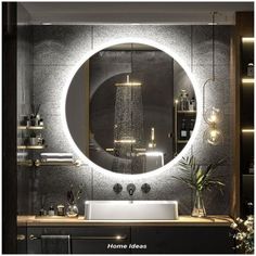 a bathroom sink under a round mirror with lights on the wall and shelves below it