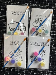 three bags with markers and pencils in them sitting on a black cloth covered table