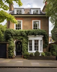 a large brick house with ivy growing all over it