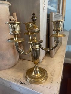 a gold candelabra sitting on top of a table