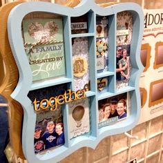 a blue shelf with pictures and magnets on it in front of a tiled wall