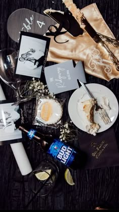 an assortment of food and drinks on a table with napkins, utensils