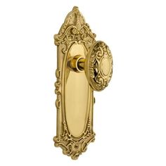 an ornate brass door handle on a white background