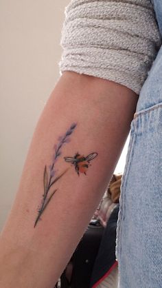 a woman's arm with a flower tattoo on the left side of her arm