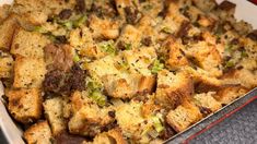 a casserole dish filled with stuffing and vegetables