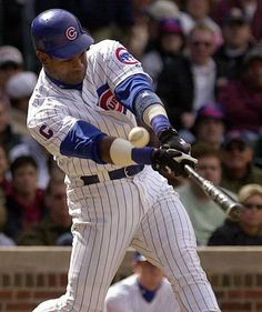 a baseball player swinging a bat at a ball