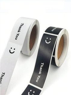 two rolls of black and white tape with smiley faces on them