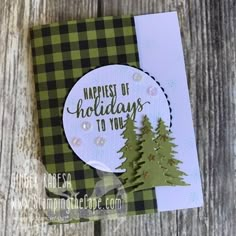 a handmade christmas card with pine trees and the words happiest of holidays to you