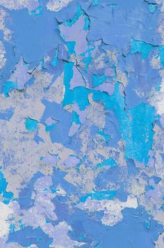 an abstract painting with blue and white paint on the wall, as well as peeling paint