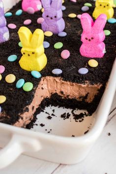 a cake with chocolate frosting and peep holes on the top is in a pan