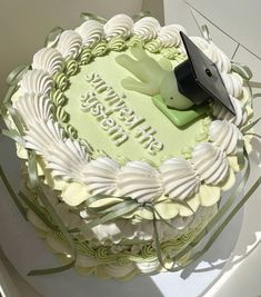 a green and white birthday cake with a bird on top