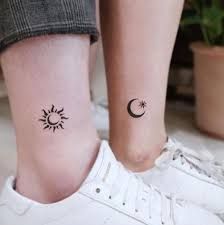 two tattoos on the legs of people with sun and moon tattoo designs on their feet