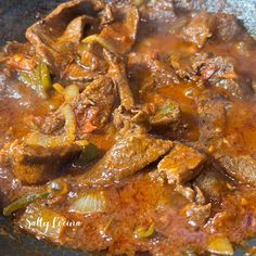 some meat and vegetables are cooking in a skillet