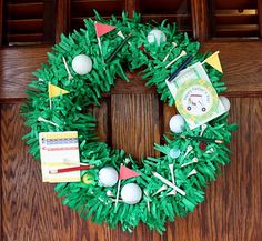 a wreath made out of green grass with golf balls and tees on the front door