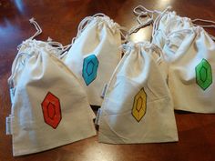 three bags with different designs on them sitting on a wooden table next to each other