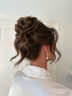 a woman with her hair in a low bun