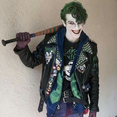 a man dressed as the joker holding a baseball bat