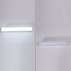 two white lights on the side of a wall next to each other in a room