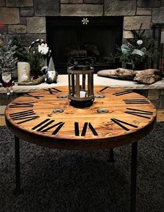 a wooden table with roman numerals on it in front of a fire place