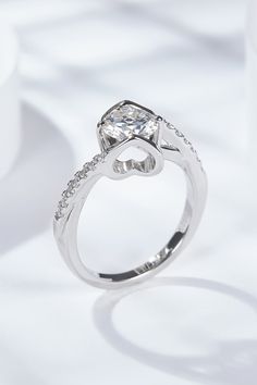 a white gold ring with an oval cut diamond