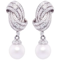 The South Sea pearl and diamond earrings feature a swirl design on the ear with 4.86 carats of round diamonds accented with 4 large custom-cut baguette diamonds weighing 1.24 carats. The tops suspend 2 very fine detachable South Sea pearls of 16mm diameter. All of our pearls are untreated: their natural color and high luster have not been enhanced in any way. All of our diamonds are of top quality (F/G-VVS, color, clarity, and cut). The earrings are one-of-a-kind. They were handmade in Italy in Baguette Diamond Earrings, Fine Pearl Jewelry, Gold Bangles For Women, Pearl Jewels, Jewellery Indian, Luxury Earrings, Pearl And Diamond Earrings, Baguette Diamonds, Diana Spencer