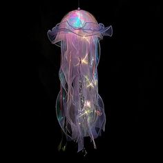 a light up jellyfish hanging in the dark