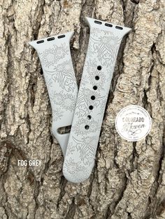 the watch band is designed to look like it has been engraved on an old tree