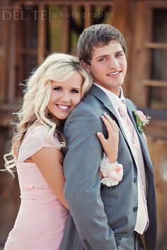 a young man and woman hugging each other