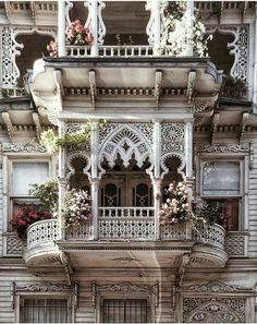 an old building with flowers on the balconies