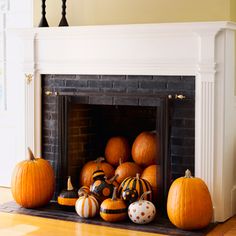 a fireplace with pumpkins and other decorations on it