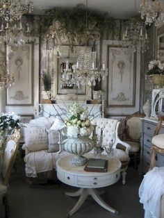 a living room filled with furniture and chandeliers