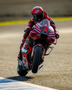 a man riding a motorcycle on top of a race track