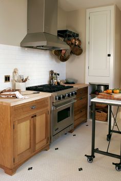 a kitchen with an oven, stove and counter tops in the middle of the room