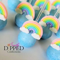 rainbow cake pops are sitting on top of each other