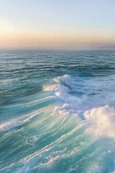 the ocean is blue and green with waves