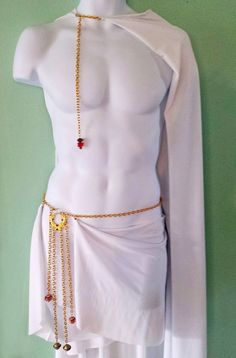 a mannequin wearing a white outfit with gold chains and beads on it's chest