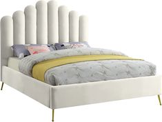 a white bed with an upholstered headboard and foot board is shown in front of a white background