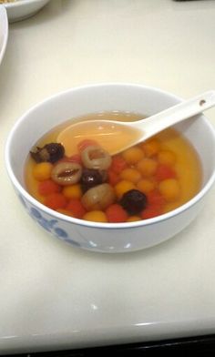 a white bowl filled with soup on top of a table