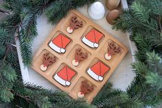 some cookies are sitting on top of a cookie sheet with santa's hats and antlers