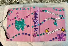 two pink notebooks decorated with bows and beads