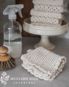 a close up of a bottle of soap on a table next to a pile of towels