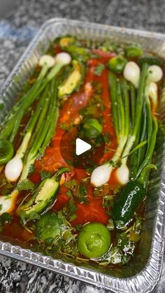 a plastic container filled with vegetables on top of a counter