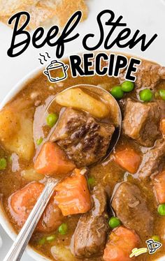 beef stew in a white bowl with peas and carrots on the side next to bread