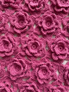 pink crocheted fabric with flowers on it