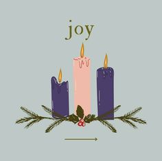 three candles with the word joy written on them and holly branches around them, surrounded by pine cones